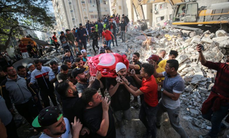 Palestine dead body of a child carried from bombed building by Israeli airforce al Rimal neighbourhood Gaza City 16 5 21 ph Mustafa Hassona AA 1024x6831717635363